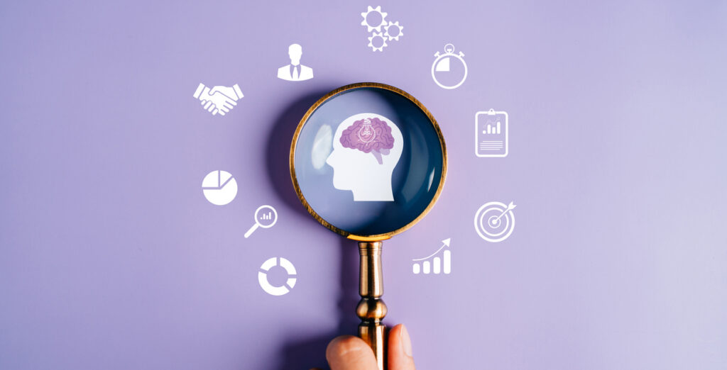 Magnifying glass on brain surrounded by icons