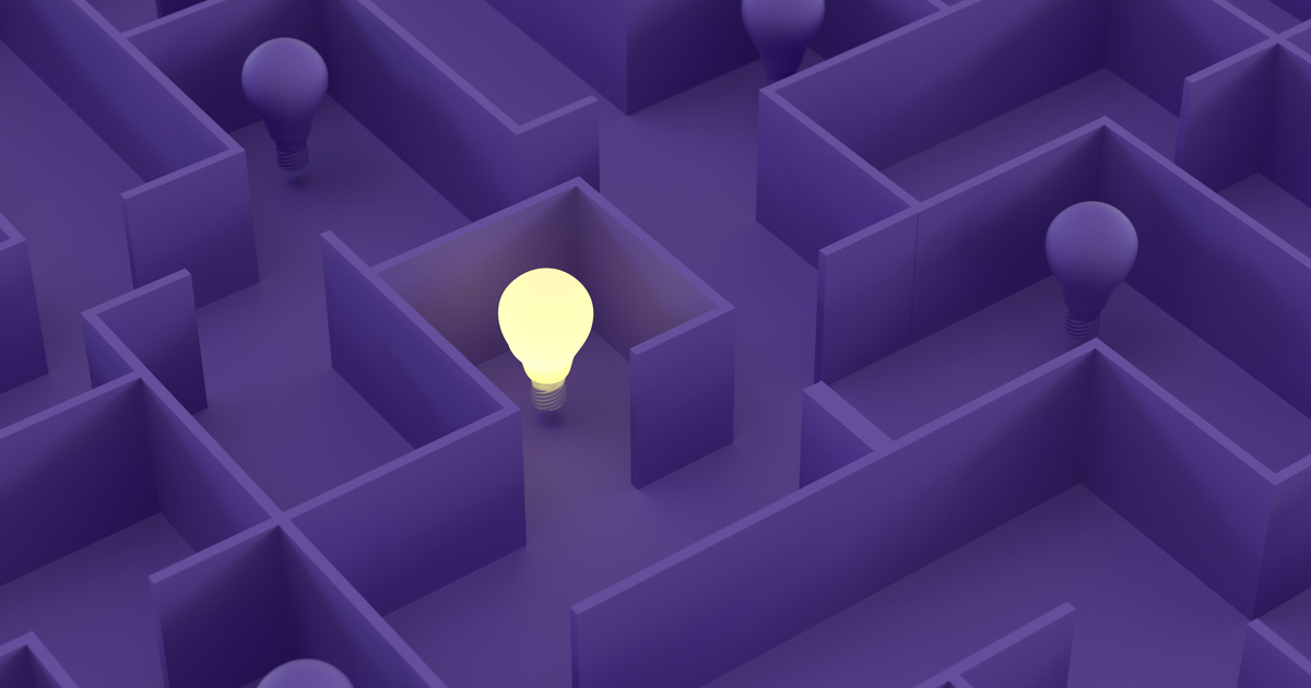 Illuminated lightbulb in a purple maze.