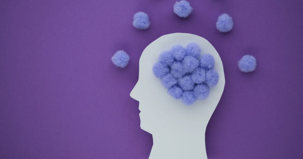 Silhouette with purple pom-poms brain on purple background.