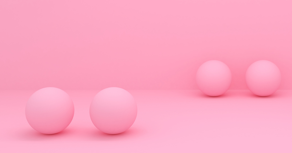 Four pink spheres on a pink background