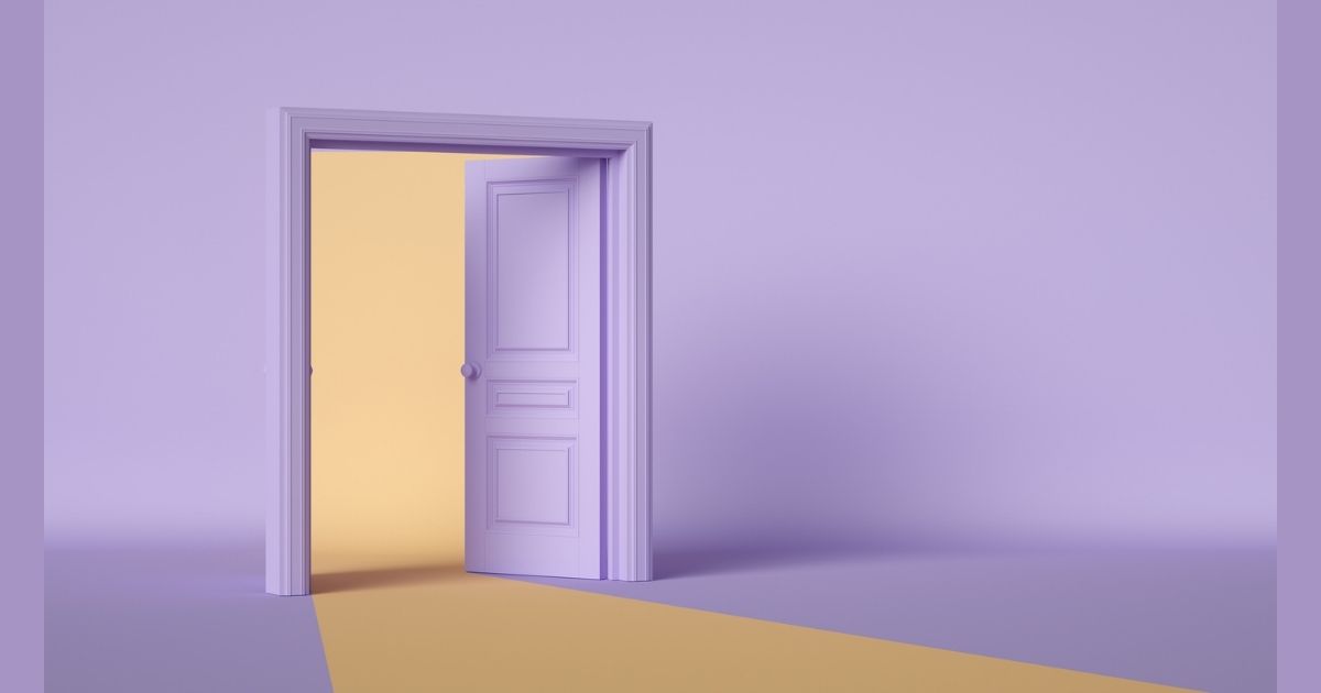 Open purple door with yellow light inside.