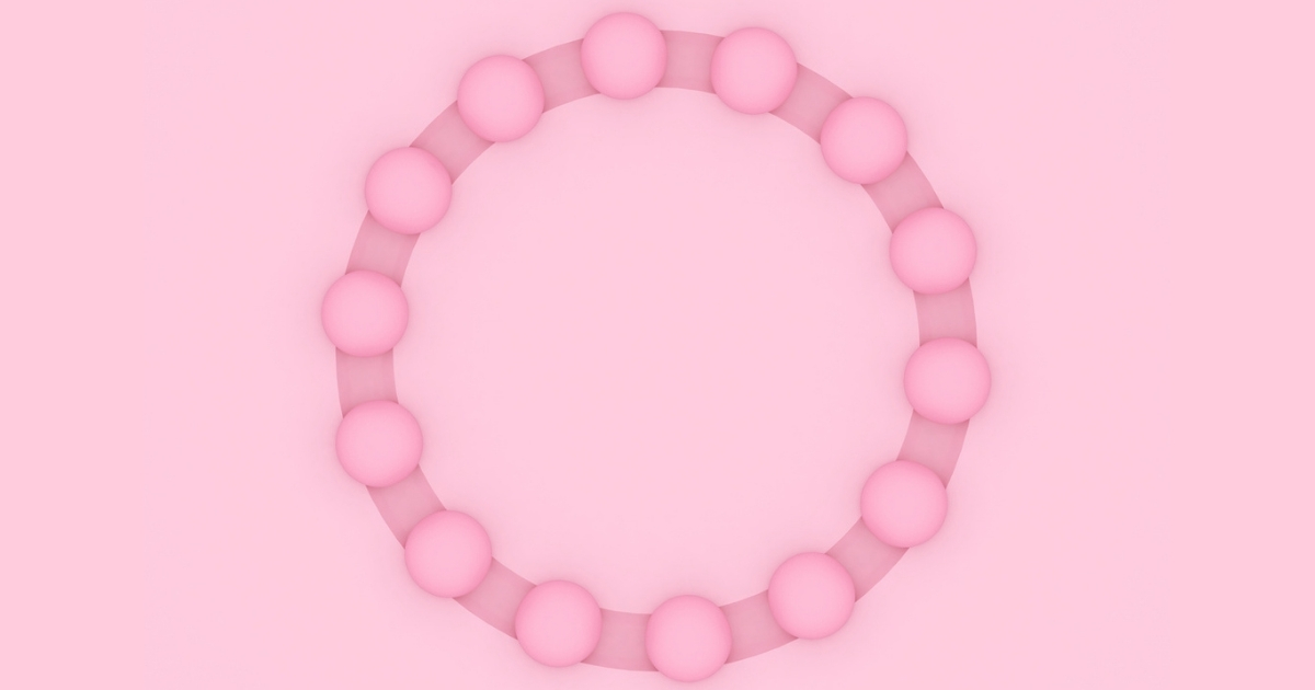 Pink circle of spheres on pink background