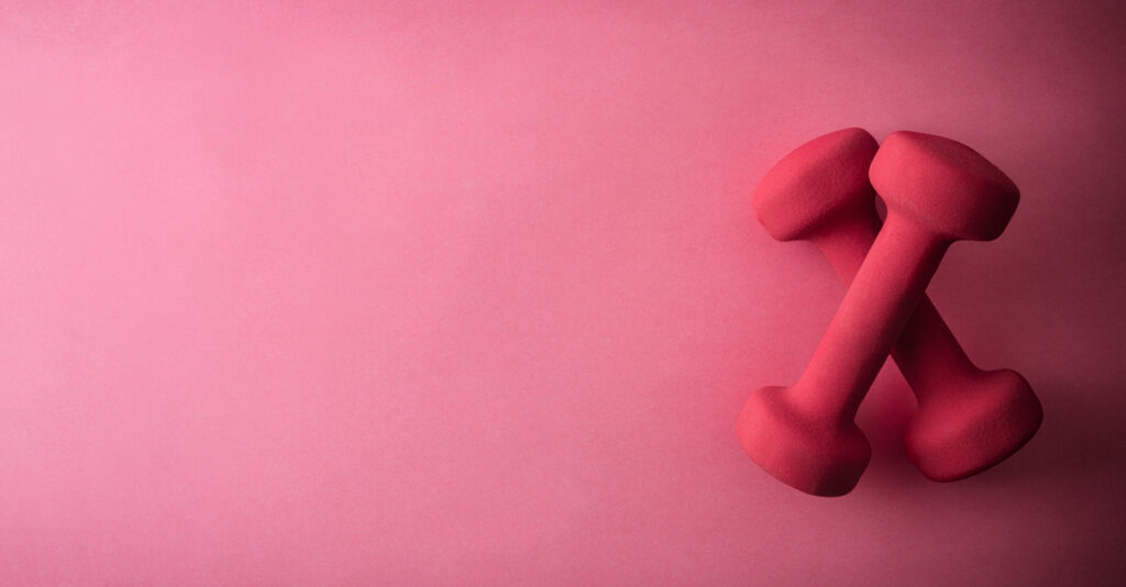 Two pink dumbbells on a pink background.
