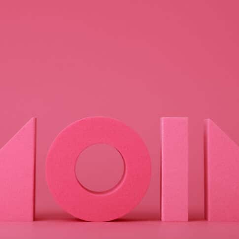 Pink futuristic background with geometric figures in a row with copy space. Concept of trendy abstract background