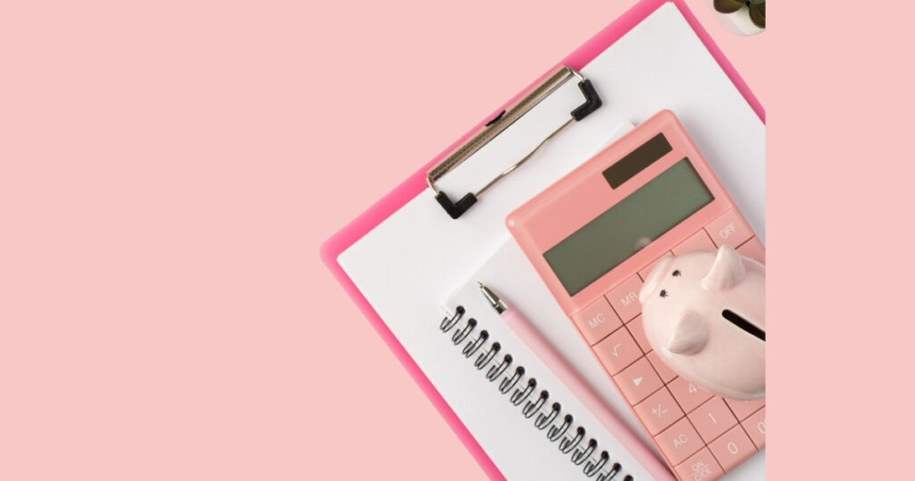 Pink calculator, clipboard, pen, and piggy bank.