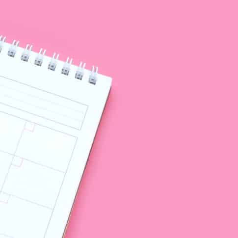 Calendar on pink background. Copy space