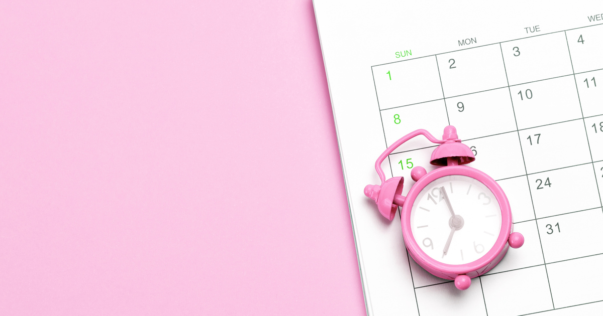 Pink clock on calendar with pink background