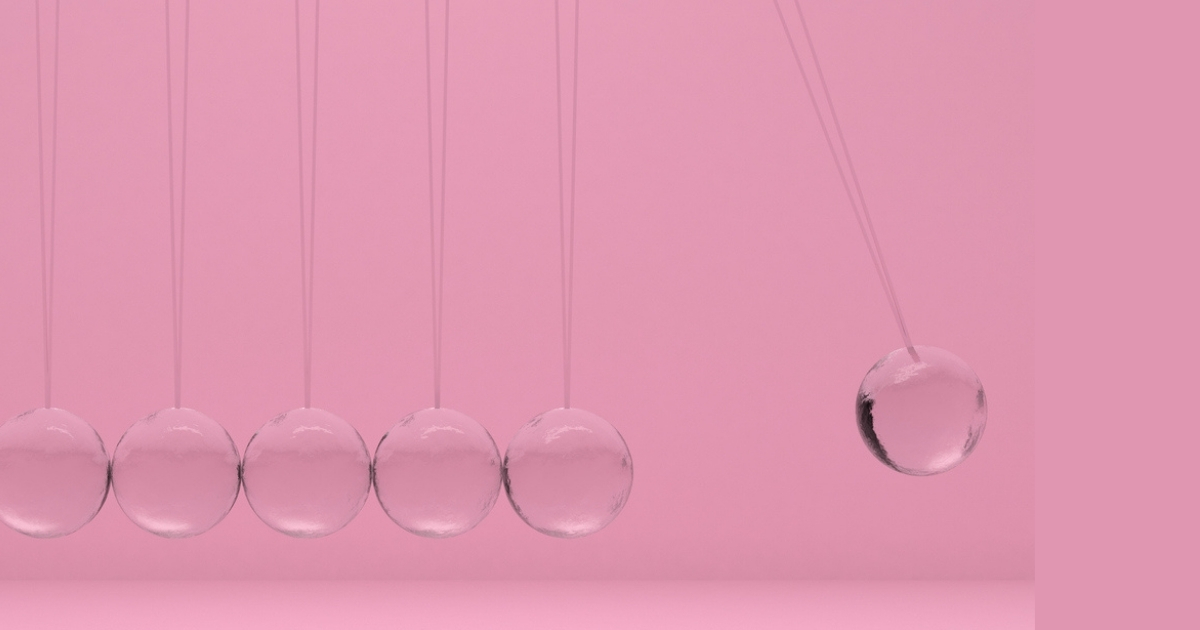Newton's cradle against pink background