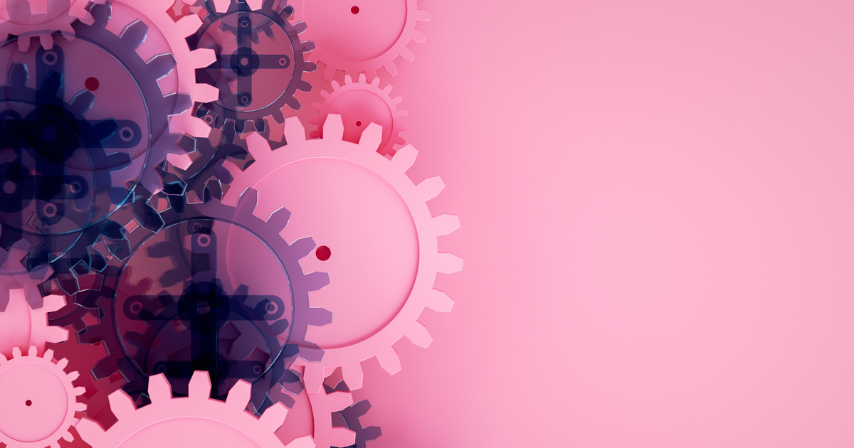 Pink and purple gears on pastel background