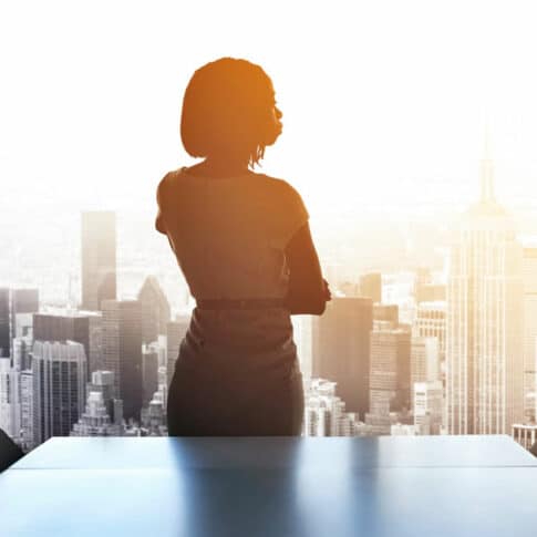 rearview shot of a woman executive staring out of a boardroom highrise window