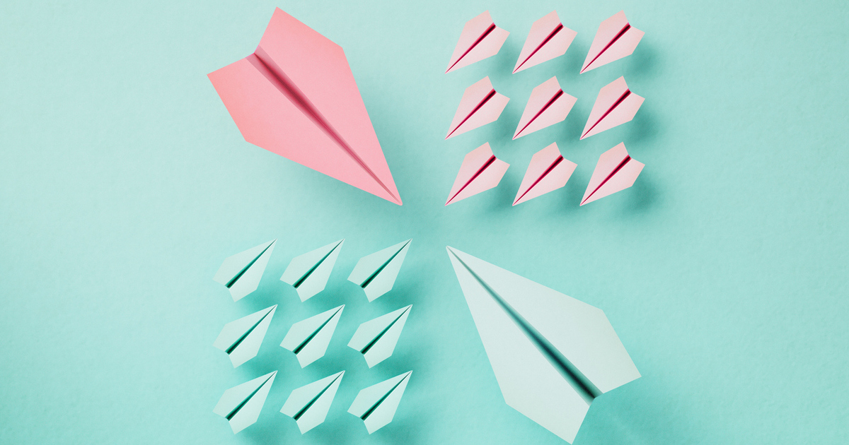 Colorful paper planes on teal background