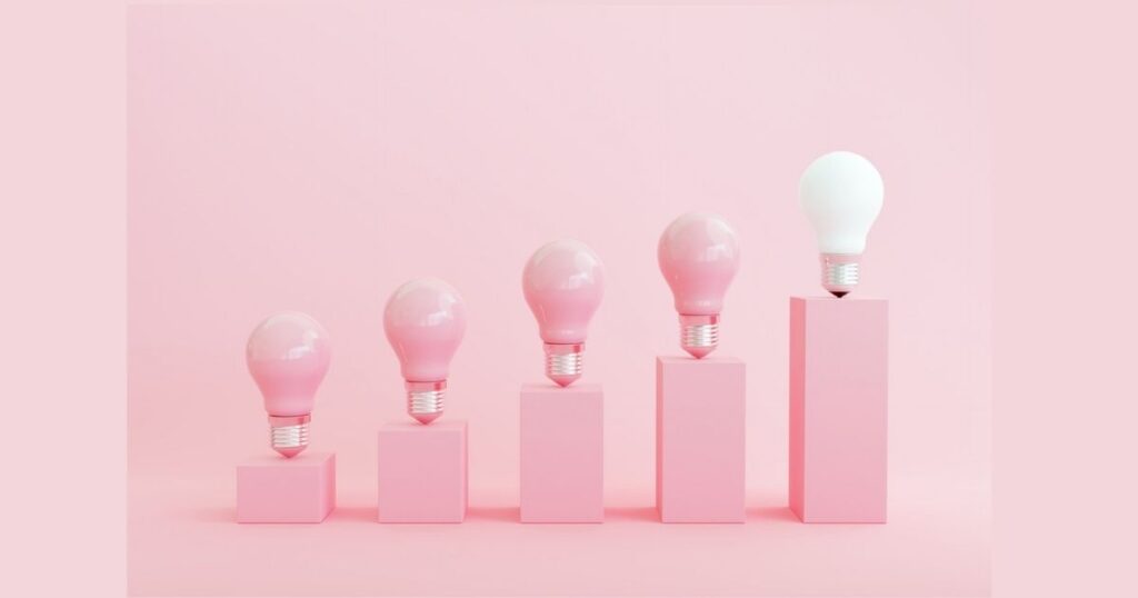 Five light bulbs on ascending pink blocks
