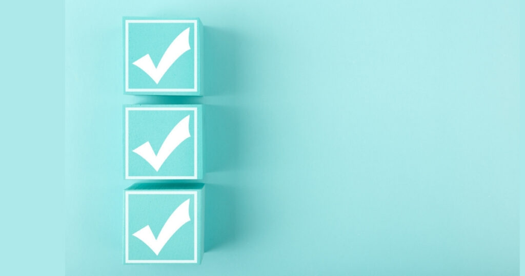 Three teal blocks with check marks on blue background.