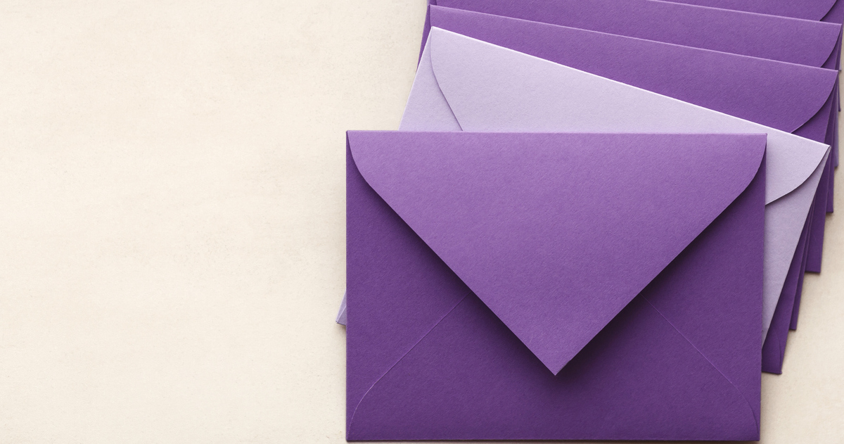 Stack of purple envelopes on beige background.