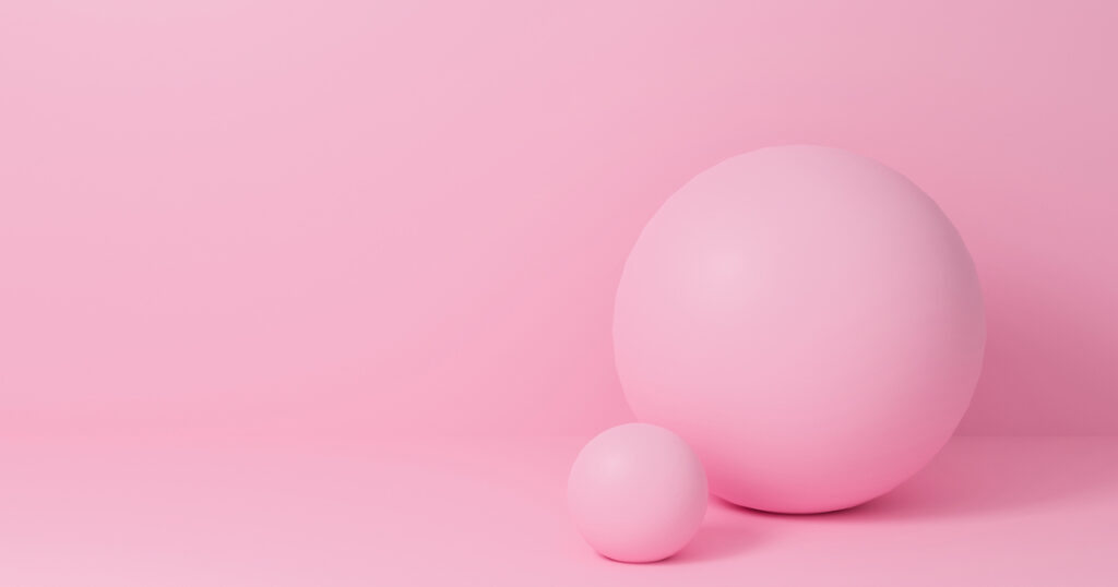 Two pink spheres on a pink background