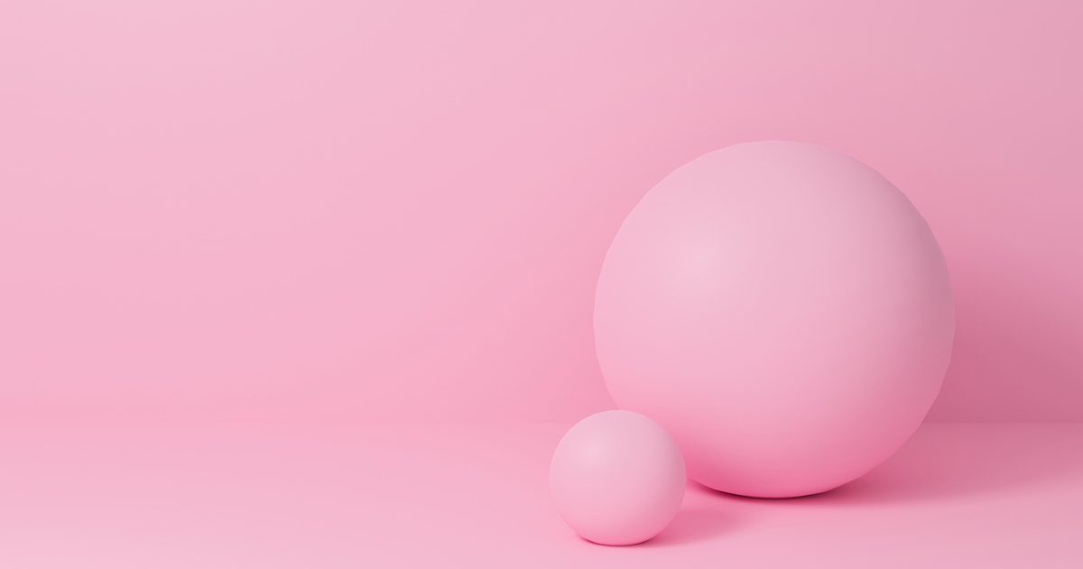 Two pink spheres on a pink background