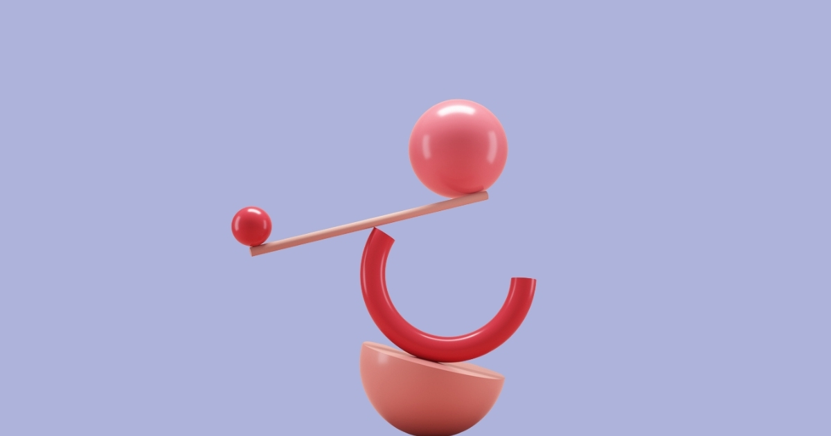 Abstract shapes balancing on a blue background.