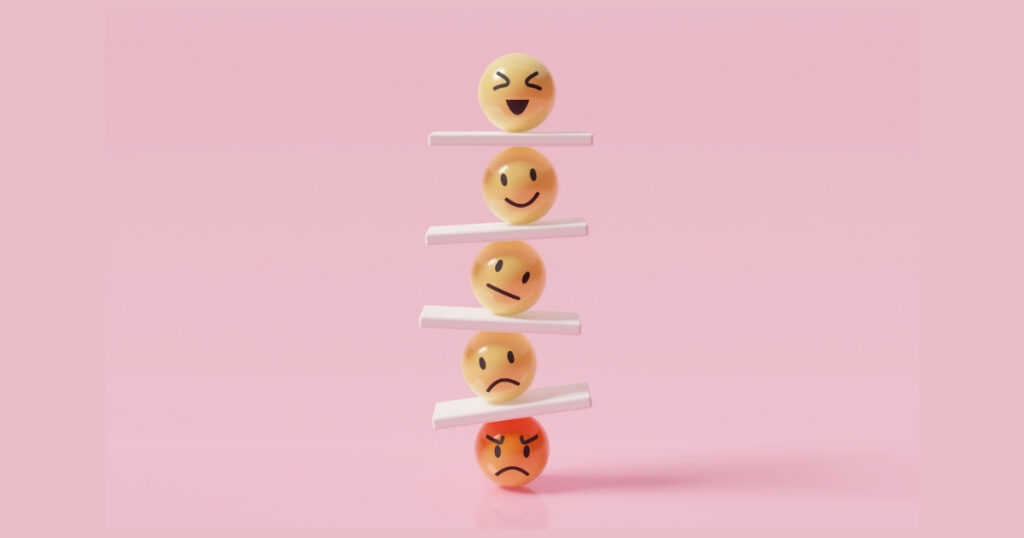 Stacked emojis showing different emotions on pink background.