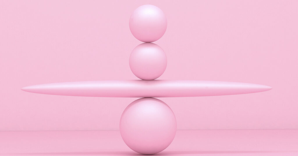 Pink spheres balancing on abstract background