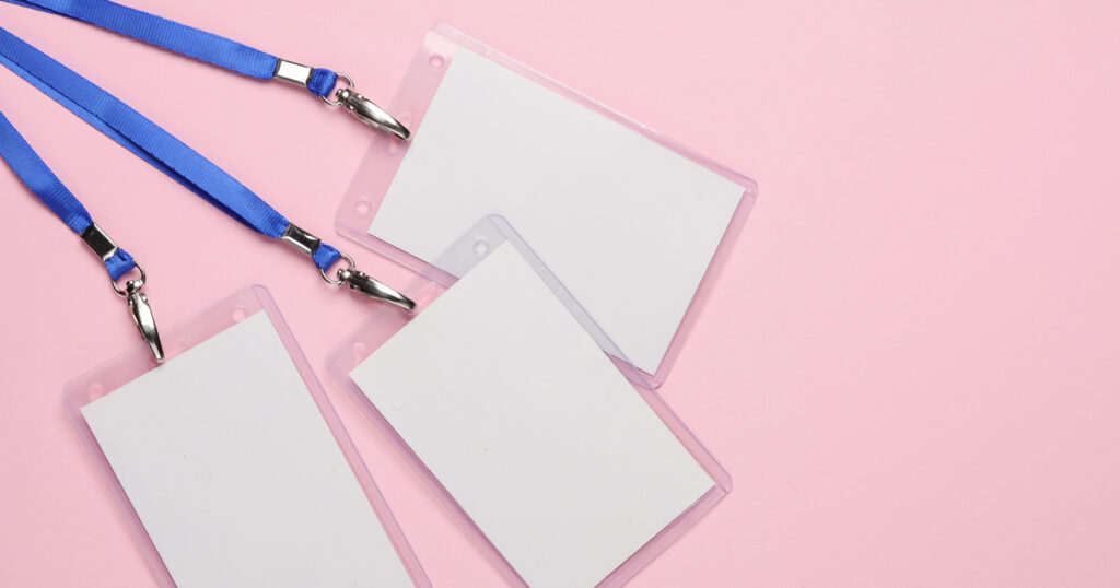 Blank lanyard name tags on pink background