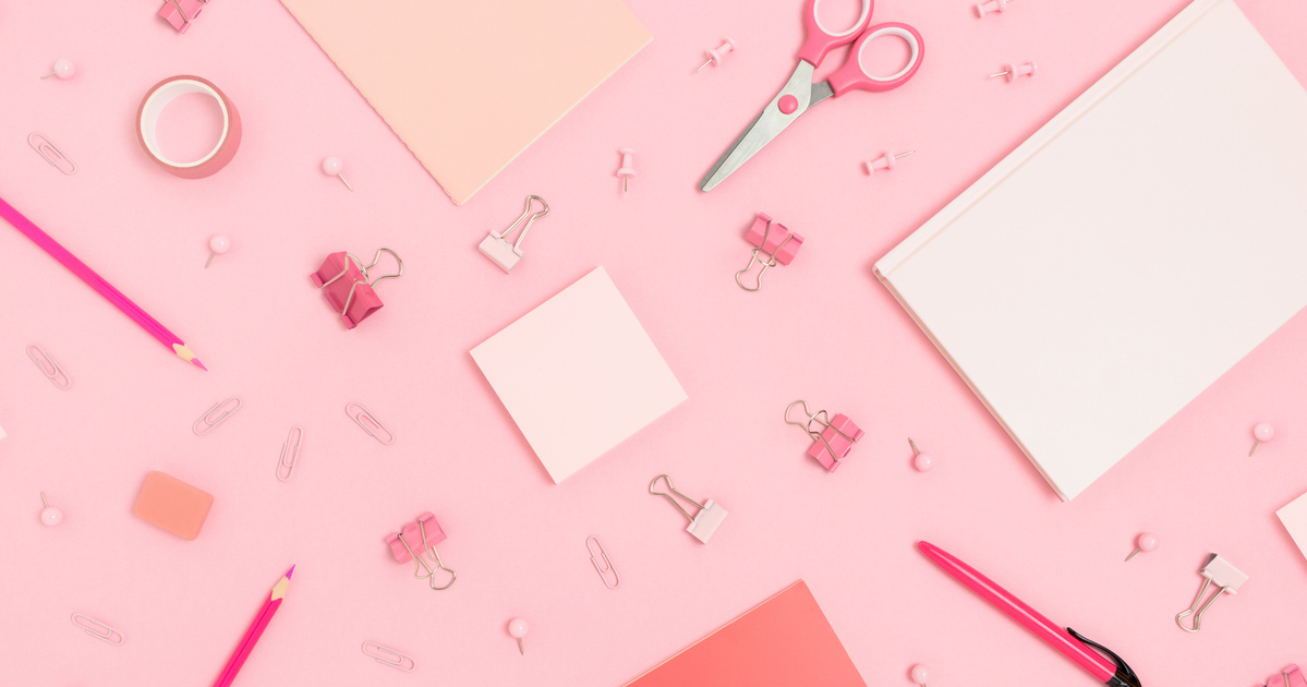 Pink office supplies on a pink background