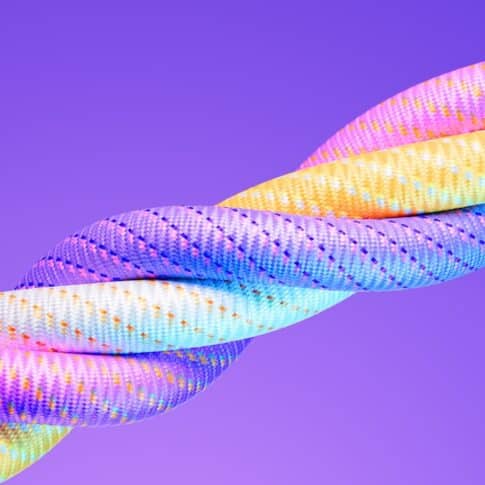 Colorful paracords on purple background. Horizontal composition. Unity concept.