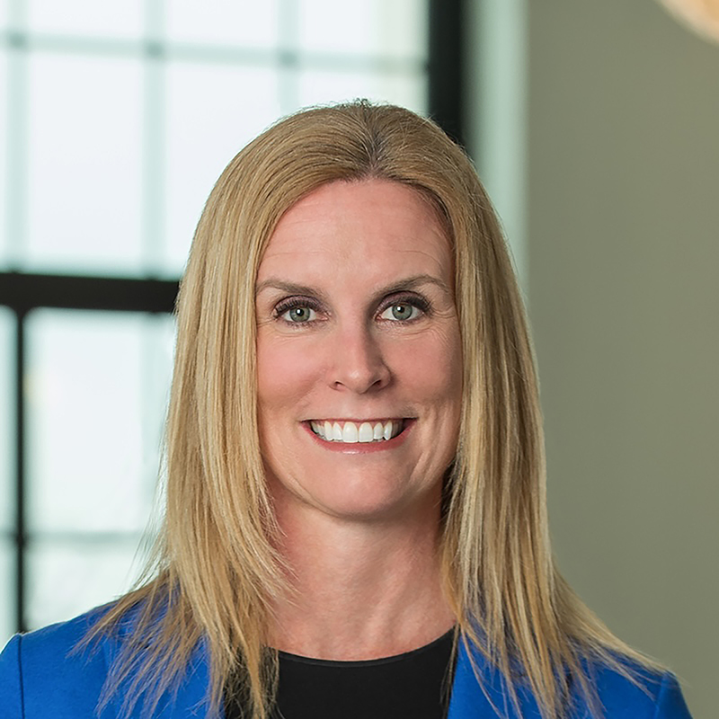 Smiling woman in blue blazer indoors