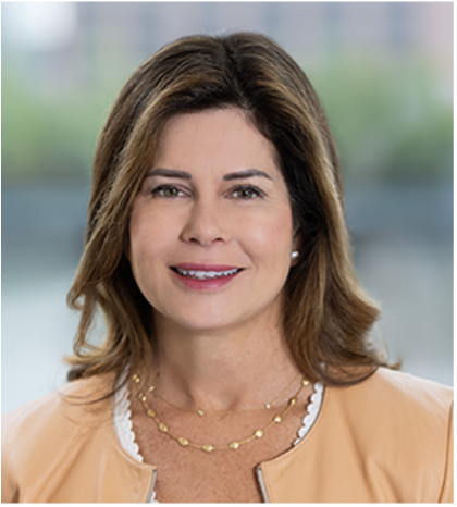 Smiling woman in beige jacket and gold necklace