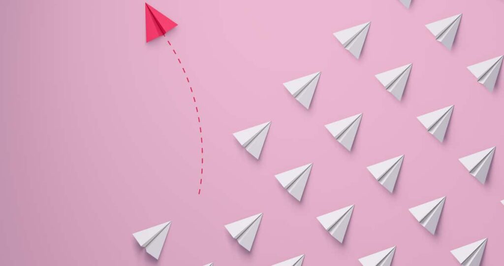 Individual and unique leader pink paper airplane changing direction. Individuality Women's leadership concept. 3d rendering.