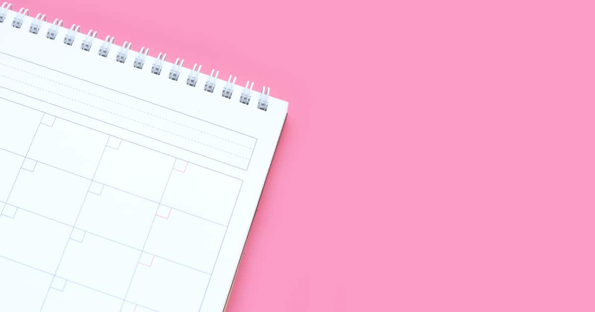 Calendar on pink background. Copy space