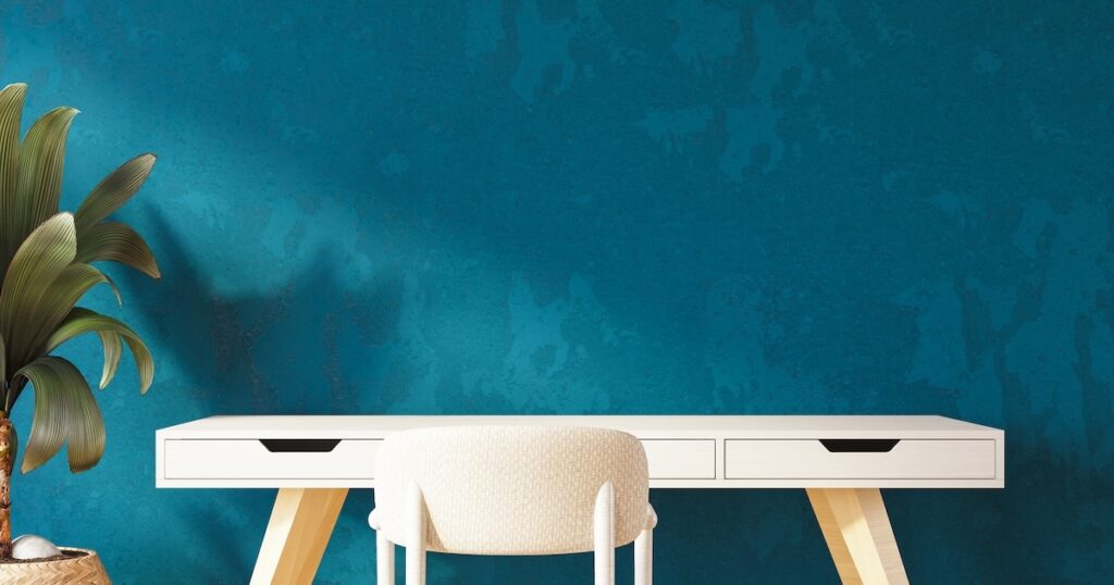 Empty Desk with Blue Wall and Sunlight.