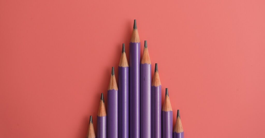 purple pencils on pink background with copy space. Back to school and Education Concept.