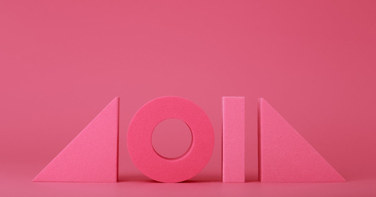 Pink futuristic background with geometric figures in a row with copy space. Concept of trendy abstract background