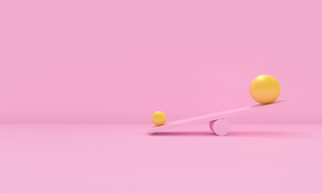 3D yellow balls on pink seesaw