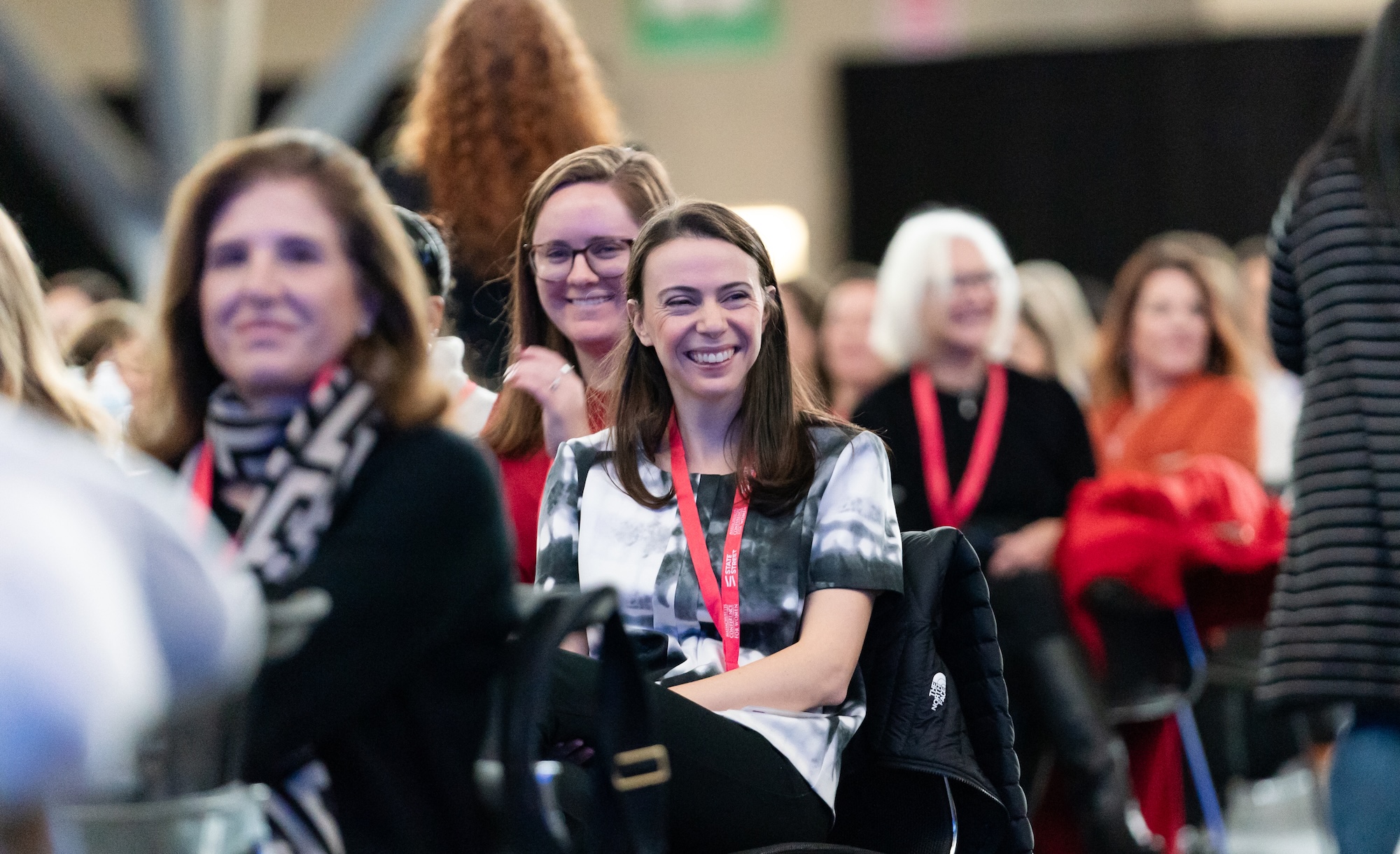 Audience members smiling at an event