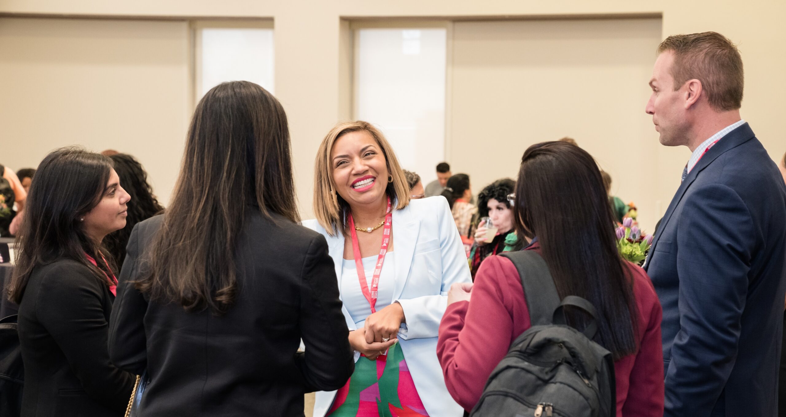 Group of people networking at a business event.