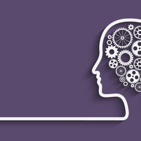 human head silhouette with gears on purple background