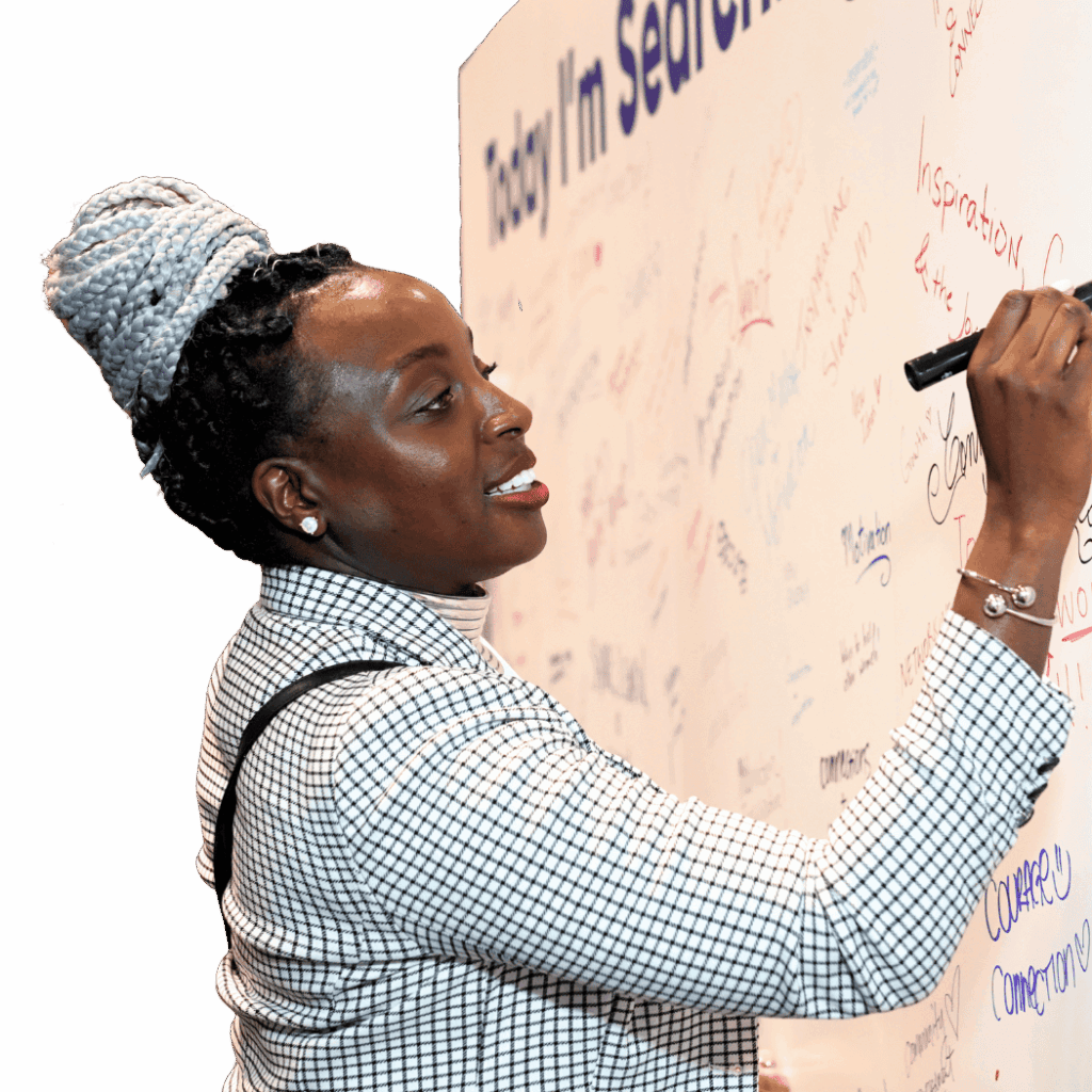 Woman writing on a signed message board