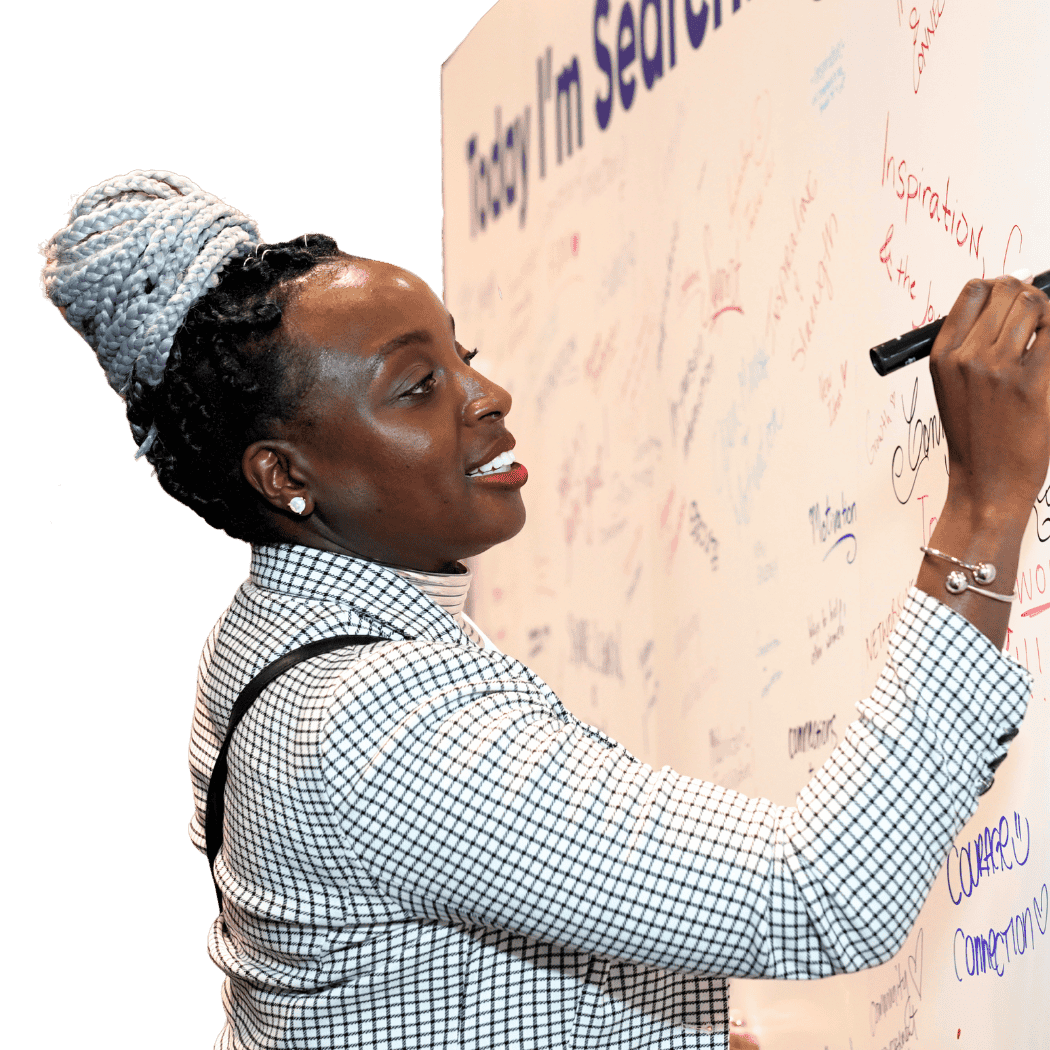 Woman writing on a signed message board