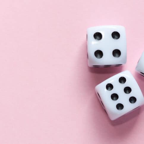 white dice on pink background