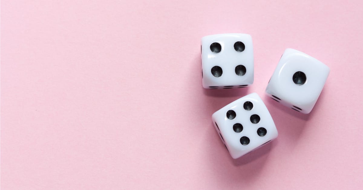 white dice on pink background