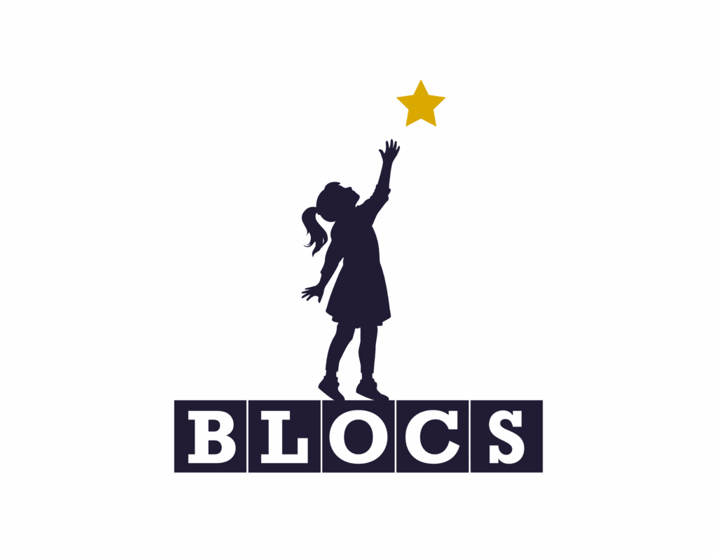 Child reaching for star above BLOCS blocks