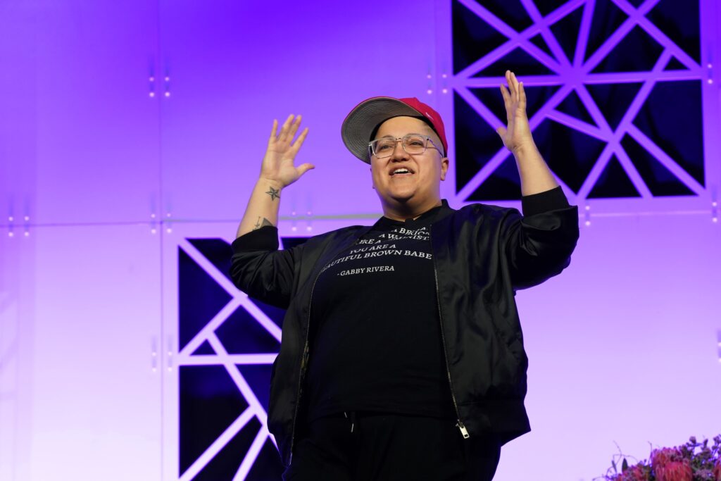 Speaker gestures dynamically on stage.