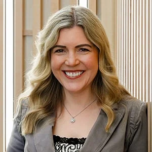 Smiling woman with long blonde hair indoors