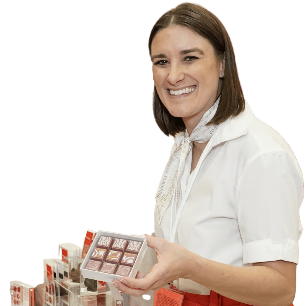 Woman showcasing gourmet chocolates at event