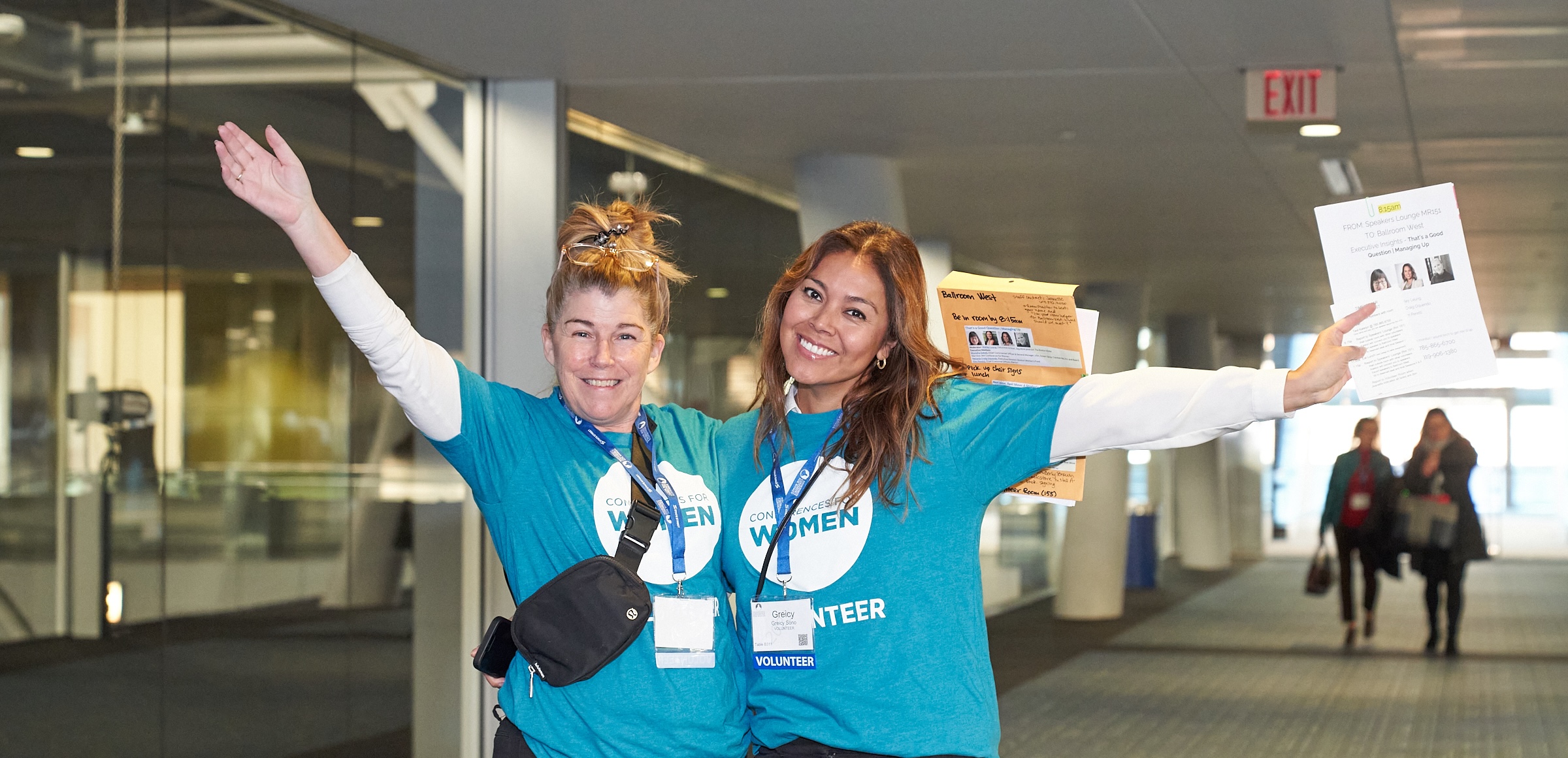 Two happy volunteers at conference event.
