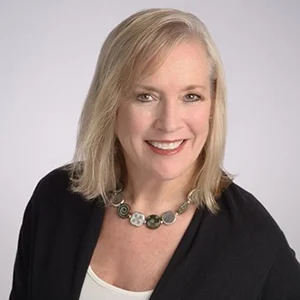 Smiling woman with blonde hair and necklace portrait