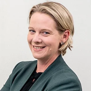 Smiling professional woman in green blazer