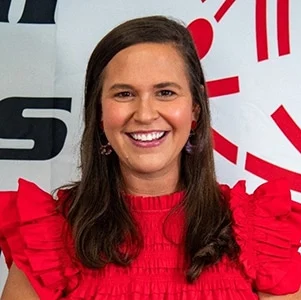 Smiling woman in red dress at event