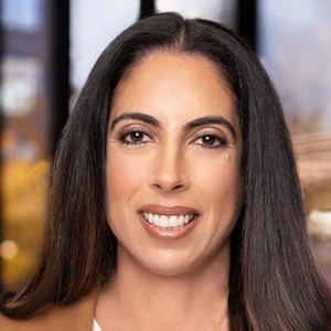 Smiling woman with long dark hair indoors